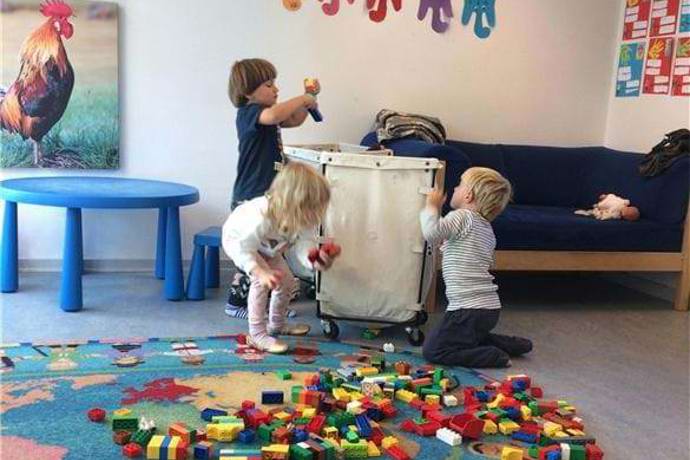 Børn bygger med duplo på en stue