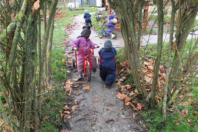 børn cykler og leger på legepladsen